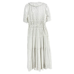 White eyelet dress with puff sleeves, high neck and gathered tiered skirt