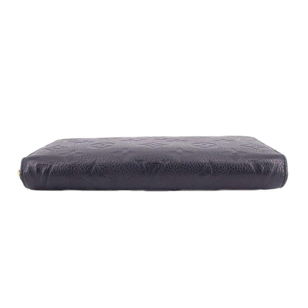 Navy embossed wallet base with smooth leather texture and monogram pattern embossing