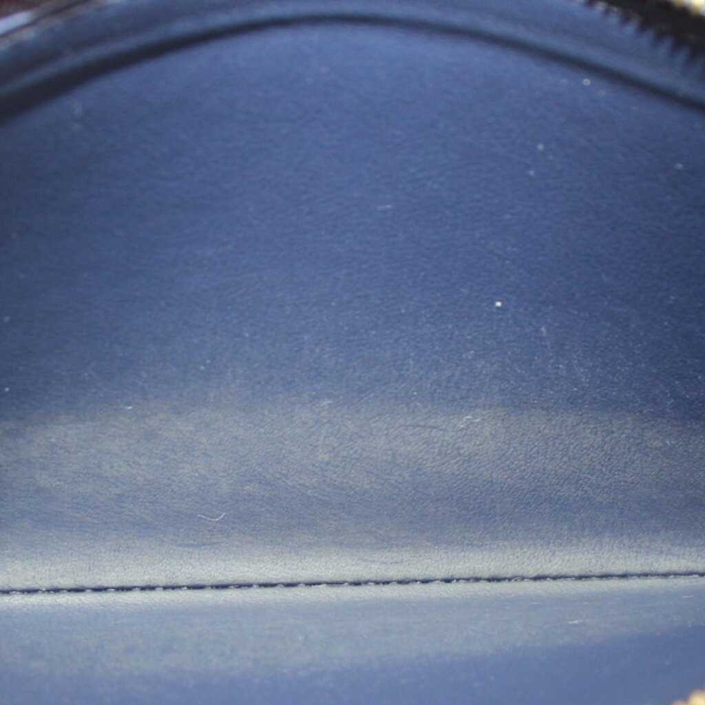 Close-up of navy wallet interior lining with stitched seam at the edge