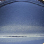 Close-up of navy wallet interior lining with stitched seam at the edge
