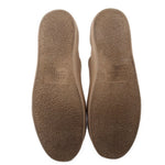 Tan suede sneakers with textured soles and embossed text