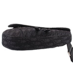 Black jacquard saddle crossbody bag with rolled top edge and side fastening strap