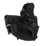 Black jacquard crossbody bag with front buckle hardware and structured flap