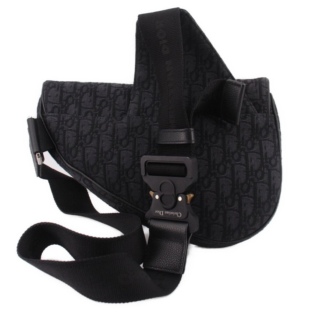 Black saddle crossbody bag with magnetic snap flap and adjustable webbing strap