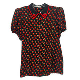 Black apple-print blouse with red apples, green details, pointed collar, short puff sleeves