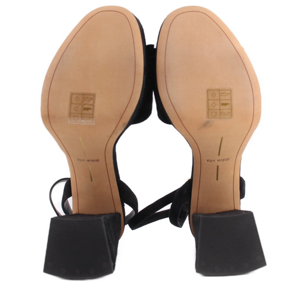 Pair of black suede heeled sandals showing outsoles and block heels