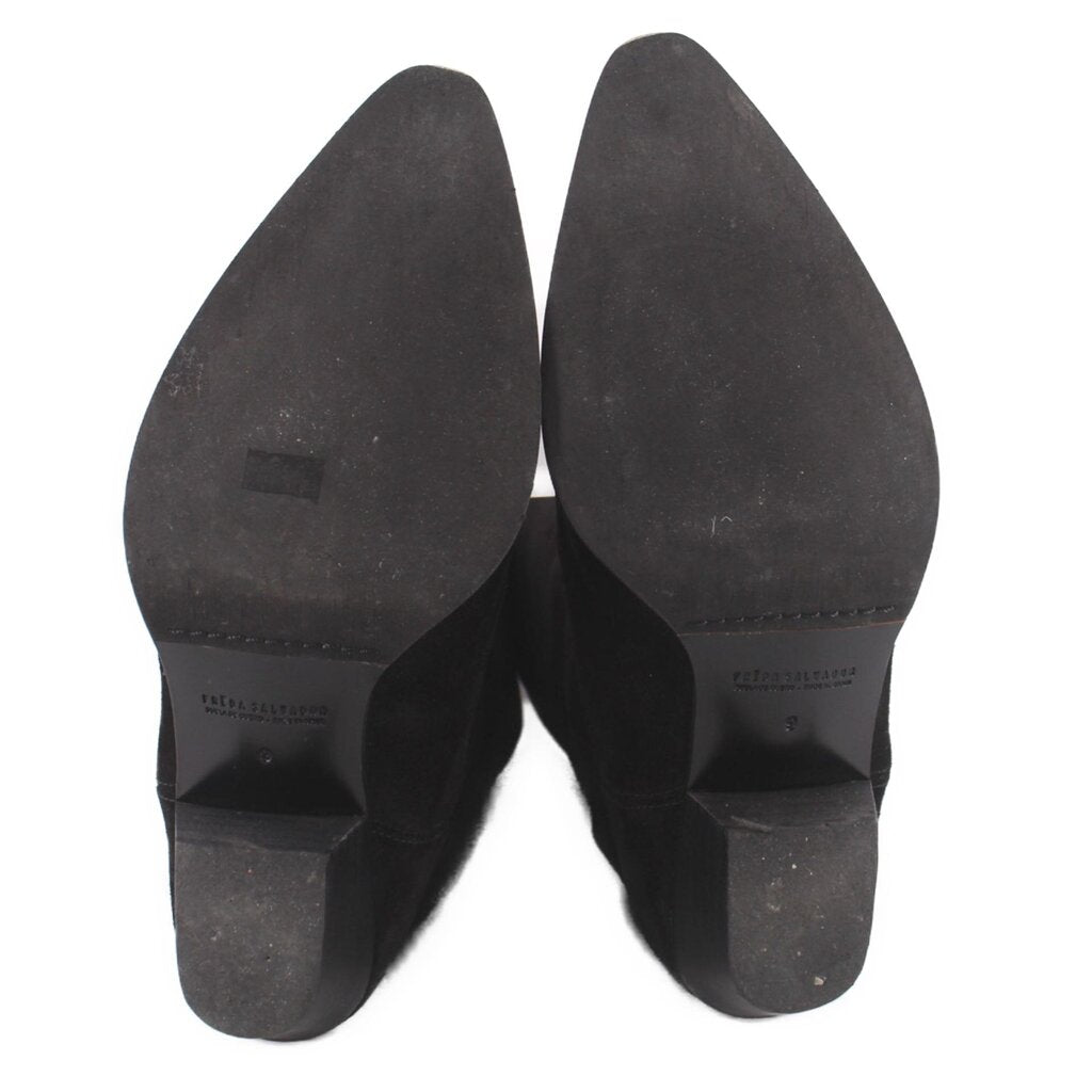 Black suede boot soles and heels with stacked heel detailing