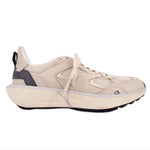 Beige mesh sneaker in side profile with dark heel panel and thick sole