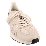 Beige mesh sneaker with layered panels, lace-up front and black toe bumper