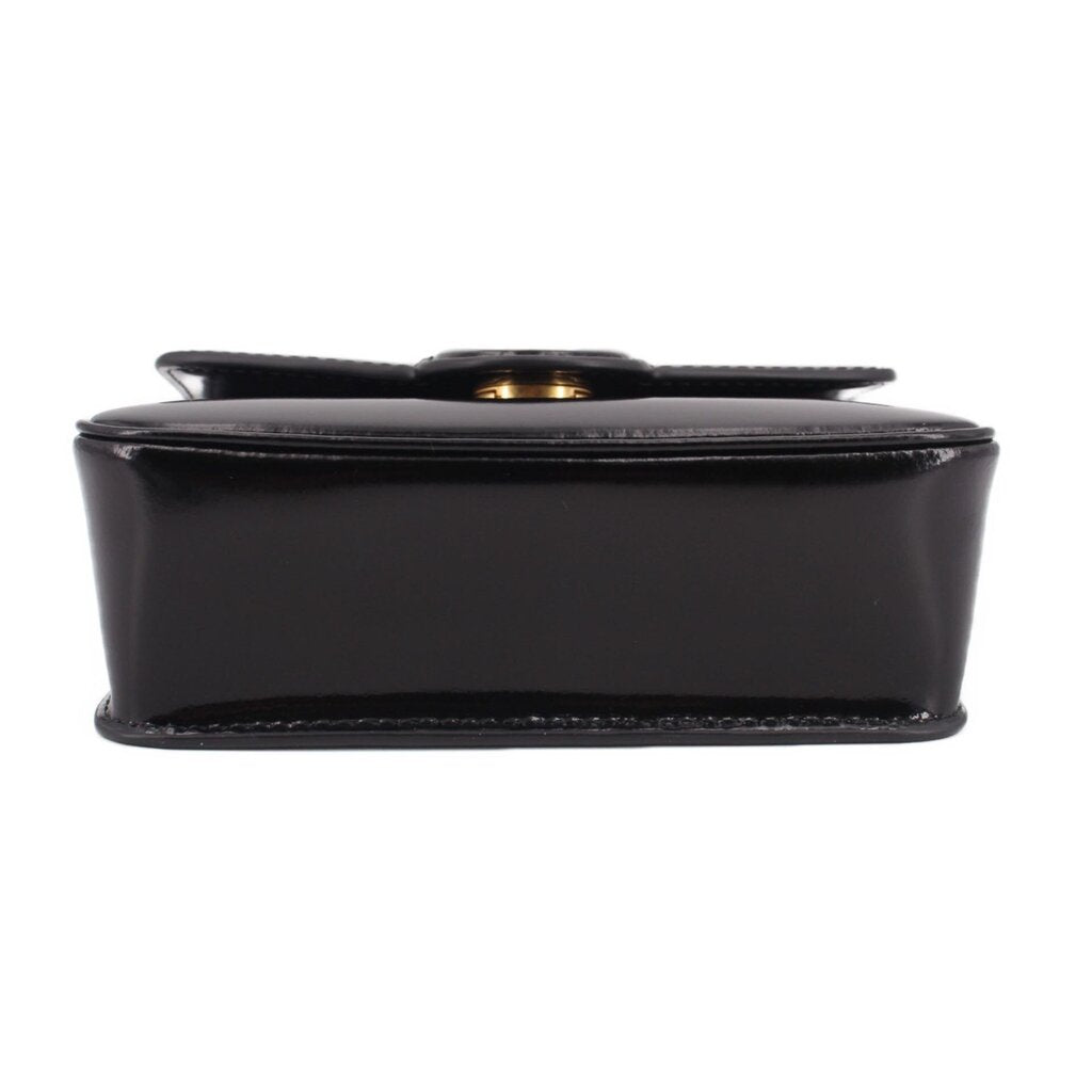Black leather bag bottom view with snap closure edge detail