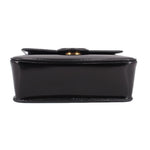 Black leather bag bottom view with snap closure edge detail