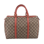 GUCCI Boston handle bag front view, tan GG canvas with rose center strap and top zip.