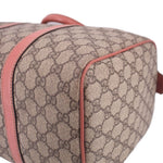GUCCI Boston handle bag corner close-up, tan GG canvas with rose piping around the seam.