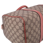 GUCCI Boston handle bag side close-up, tan GG canvas with rose edge piping and stitching.