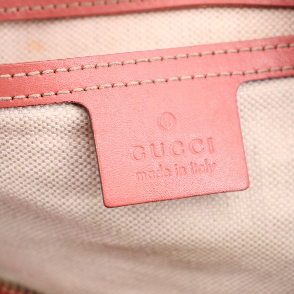 GUCCI interior label on pink lining, embossed “GUCCI” and “made in Italy”.