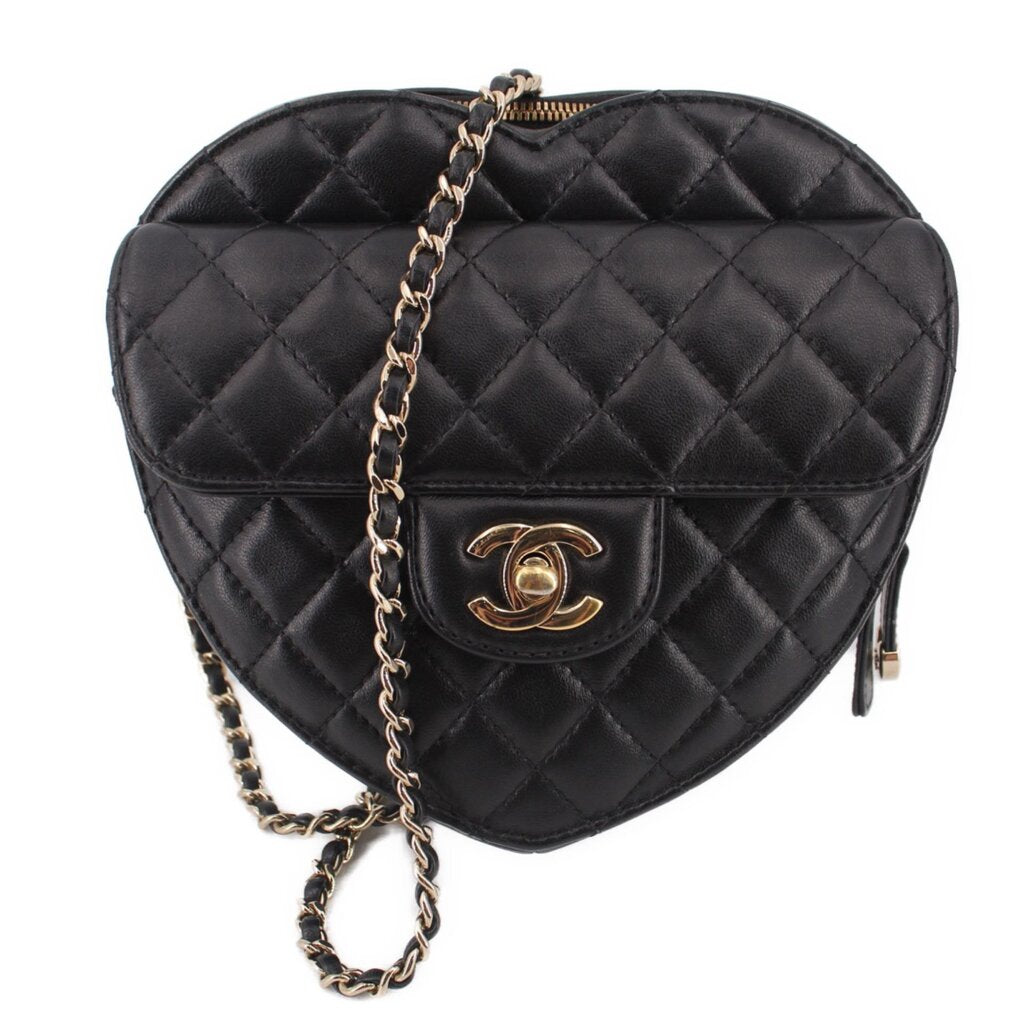Black quilted heart crossbody bag with gold-tone CC logo and chain strap.