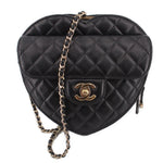 Black quilted heart crossbody bag with gold-tone CC logo and chain strap.
