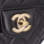 Gold-tone CC logo detail on black quilted heart crossbody bag.