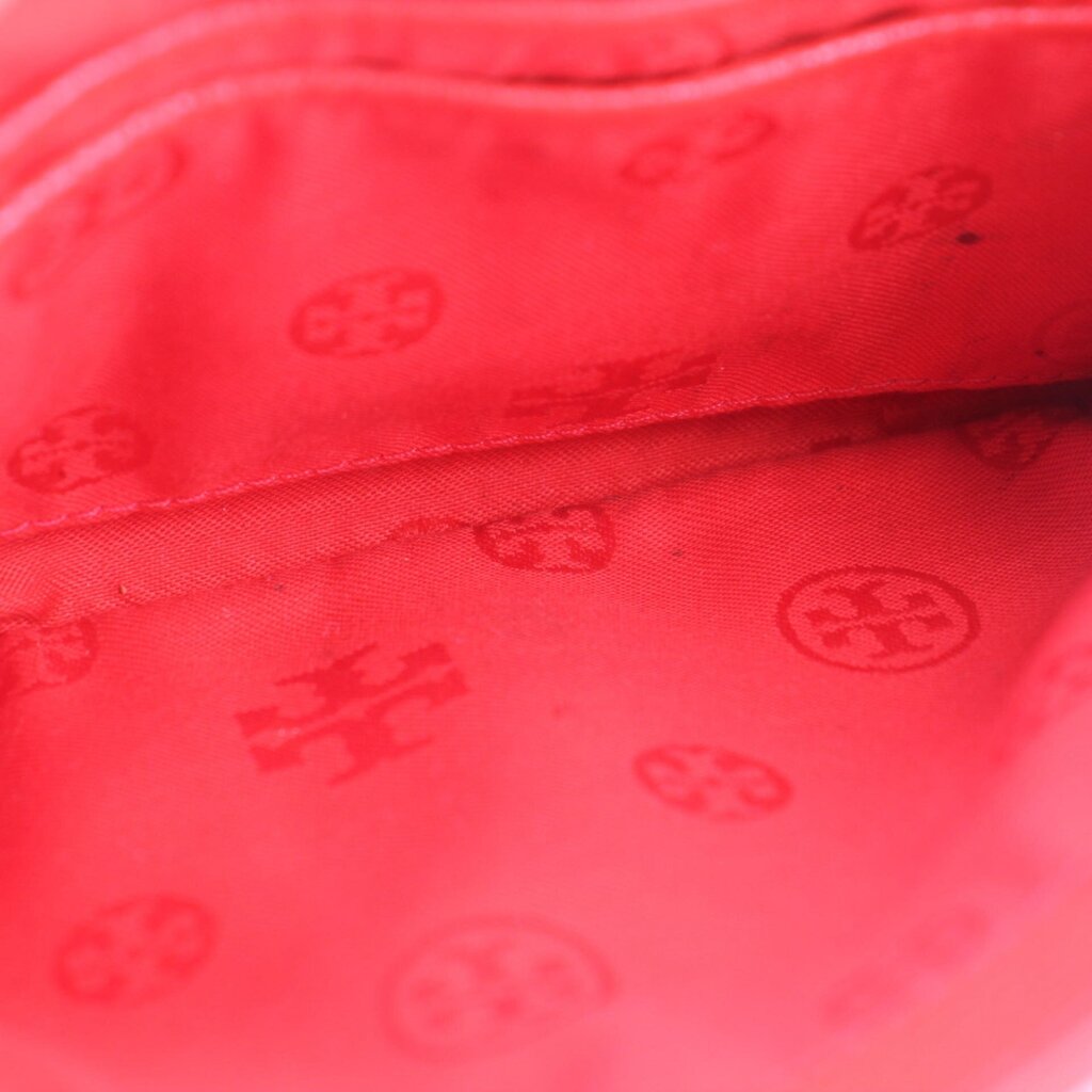 Red fabric lining with subtle TORY BURCH logo pattern