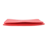 Red leather crossbody bag flap edge with snap closure, smooth trim