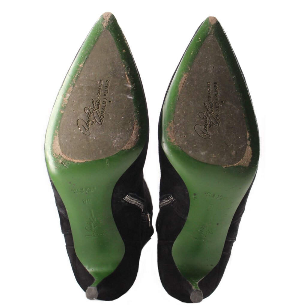 Knee-high boots showing green interior lining and signature on the insole
