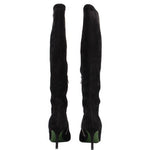 Back view of black knee-high heeled boots with green heel accents