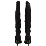 Back view of black knee-high heeled boots with green heel accents