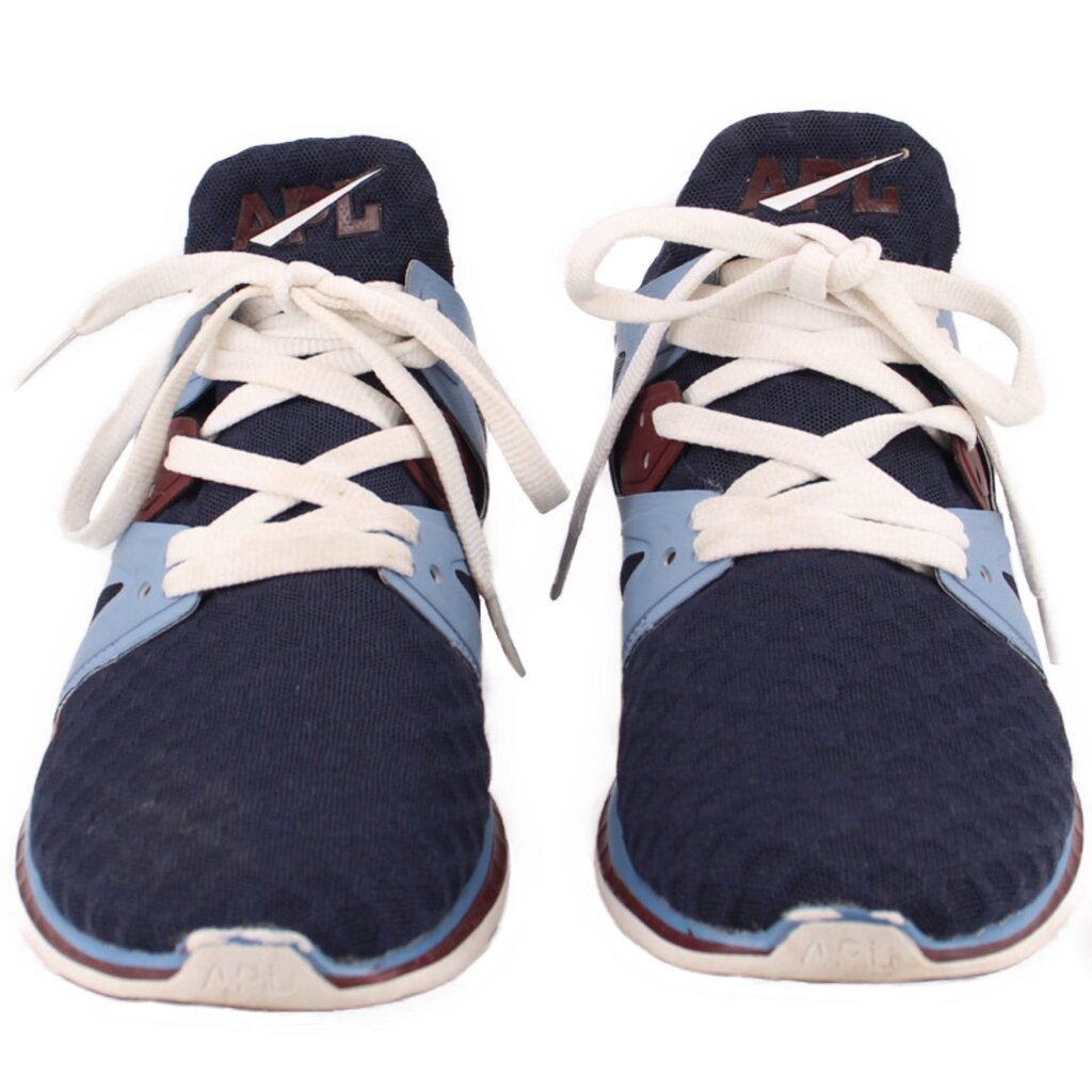 Navy mesh sneakers pair with white laces, light blue accents, and brown trim