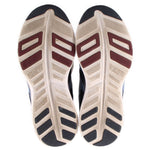 Shoe soles for navy mesh sneakers with textured traction and brown-red accents