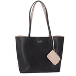 Black reversible tote bag with kate spade logo and beige hanging tag.