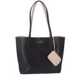 Black reversible tote bag with kate spade logo and beige hanging tag.