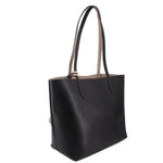 Black reversible tote bag, angled view, with twin top handles.