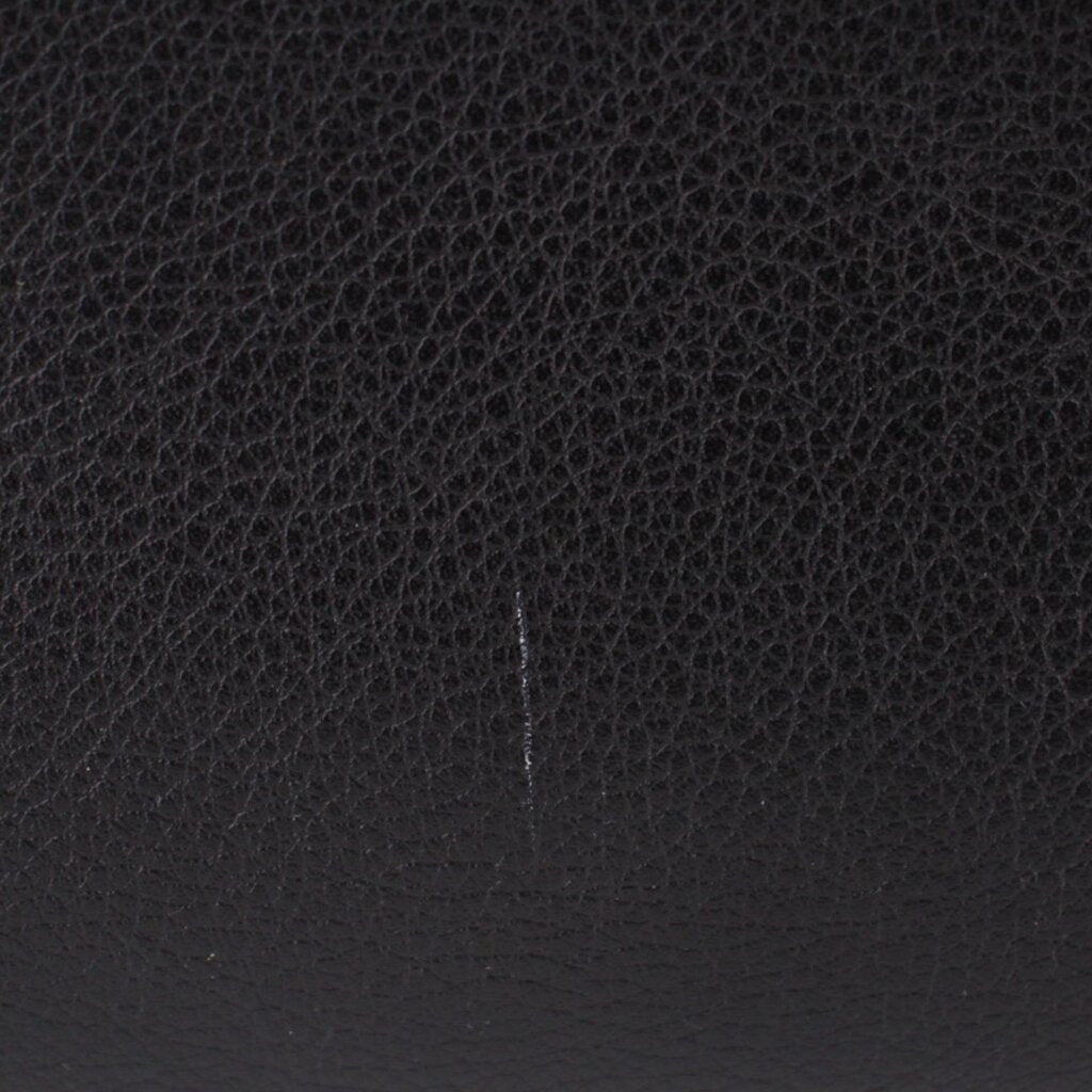 Black interior panel with subtle stitching line and pebbled texture.
