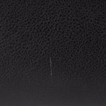 Black interior panel with subtle stitching line and pebbled texture.