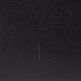 Black interior panel with subtle stitching line and pebbled texture.