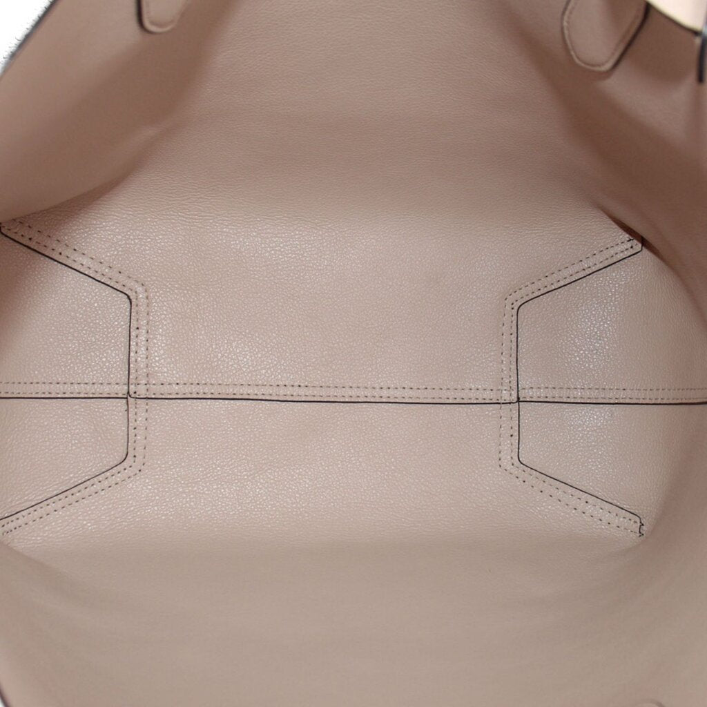 Beige interior lining of reversible tote bag with stitched panels.