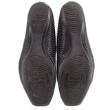 Black perforated flat shoe soles with textured tread and logo