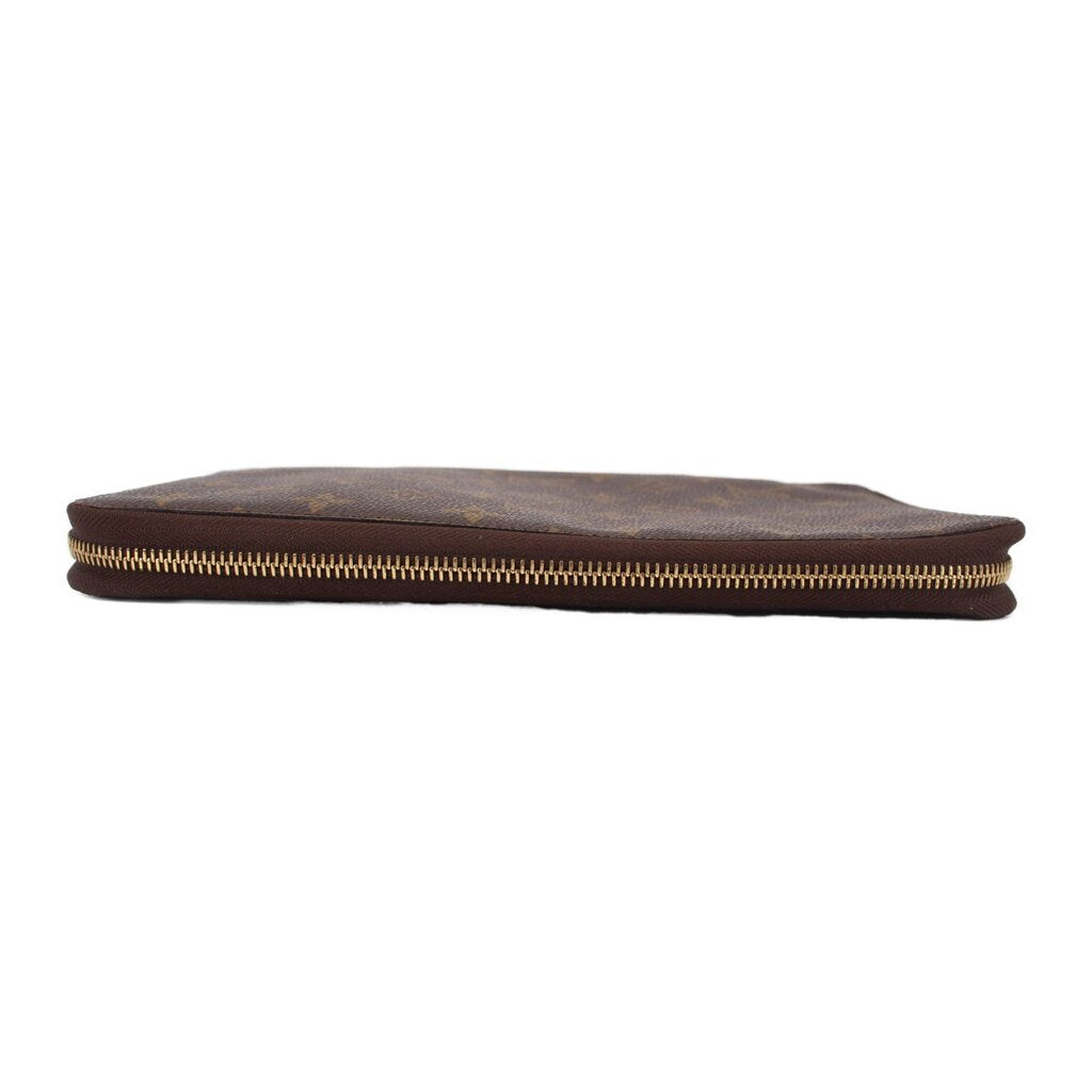 LOUIS VUITTON Voyage organizer wallet bottom view with gold-tone zipper edge.