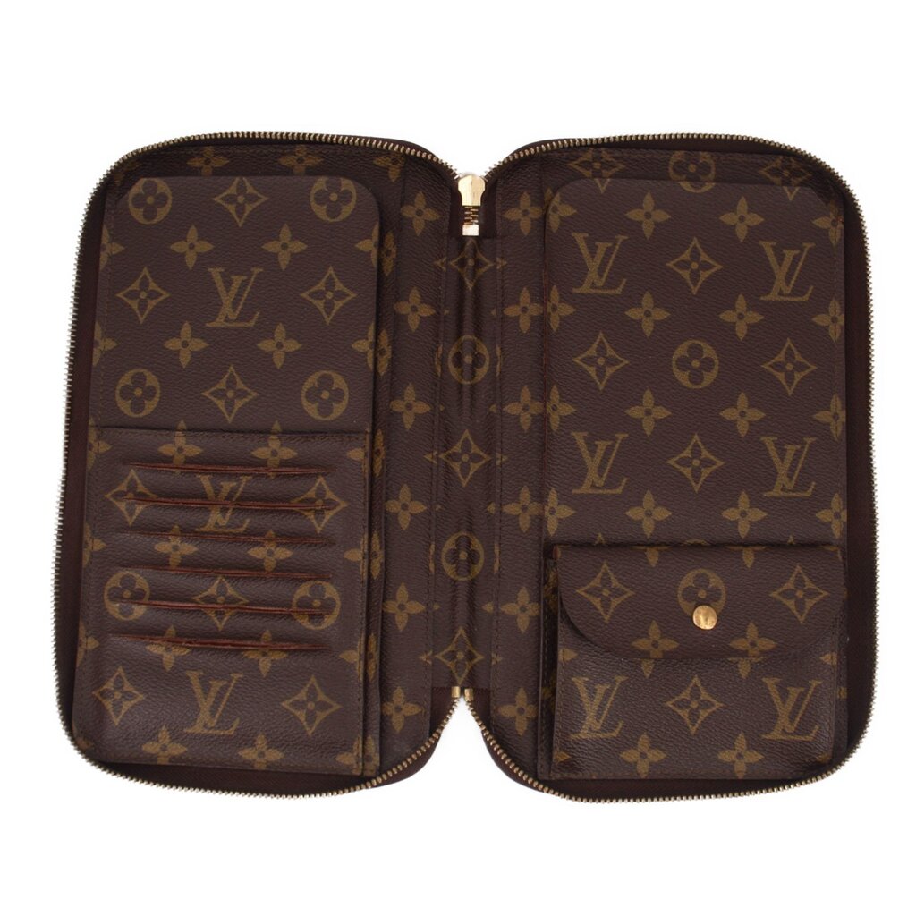 LOUIS VUITTON Voyage organizer wallet opened, showing inner card slots and monogram lining.