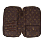 LOUIS VUITTON Voyage organizer wallet opened, showing inner card slots and monogram lining.