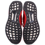 Black rubber outsoles with white traction cutouts for red knit sneakers.