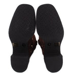 Brown suede boots with branded treaded outsole and logo pattern on heel