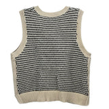 Cream and black sleeveless knit top with ribbed crew neck and allover pattern