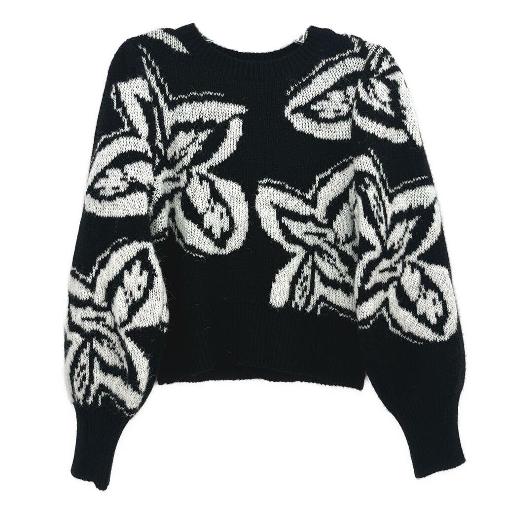 Black knit sweater with crew neck and large white graphic print, long sleeves.