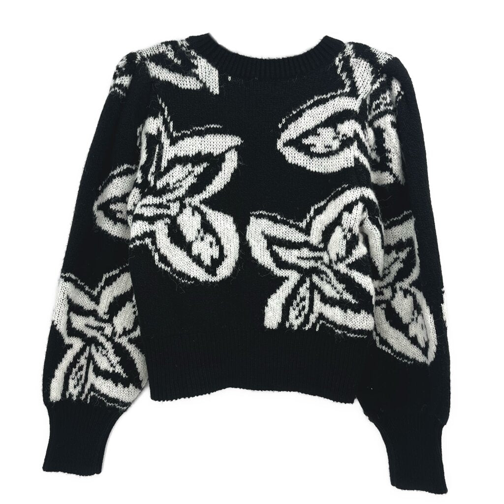 Black knit crewneck sweater with allover white graphic print and ribbed cuffs/hem.