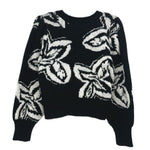 Black knit crewneck sweater with allover white graphic print and ribbed cuffs/hem.