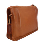 Tan leather clutch bag with shoulder strap, dangling chain detail, top zipper.