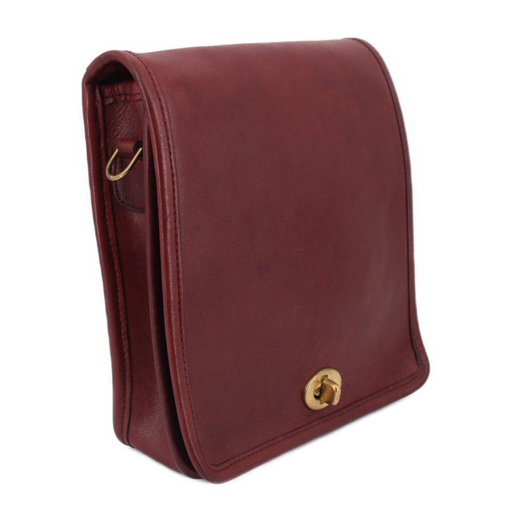 Oxblood leather compact pouch shoulder bag with flap and brass snap clasp