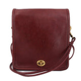 Oxblood leather compact crossbody bag with flap and adjustable shoulder strap
