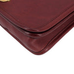 Oxblood leather bag corner with stitched edge and rounded fold detail
